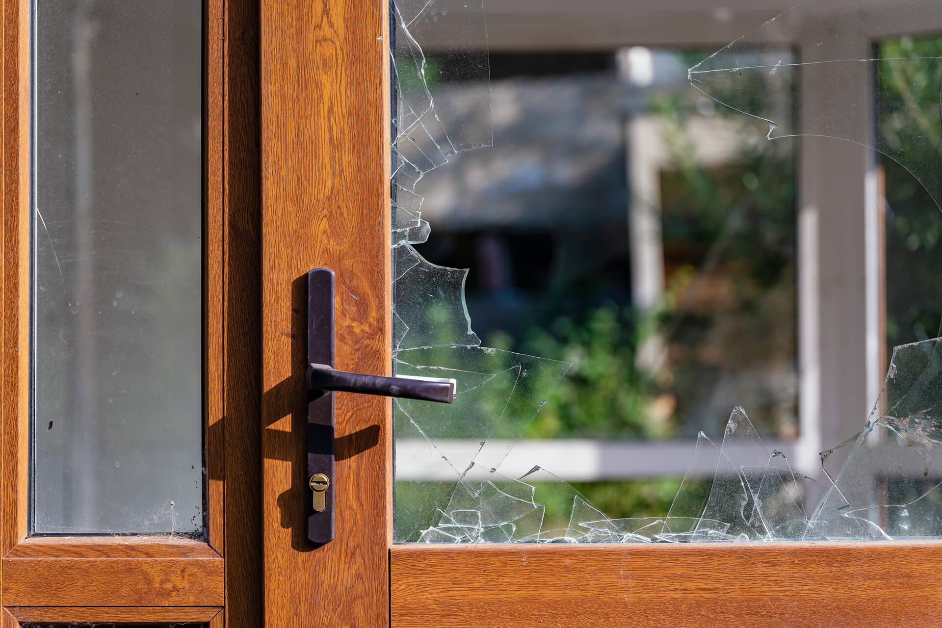 Exterior door with a broken glass insert.