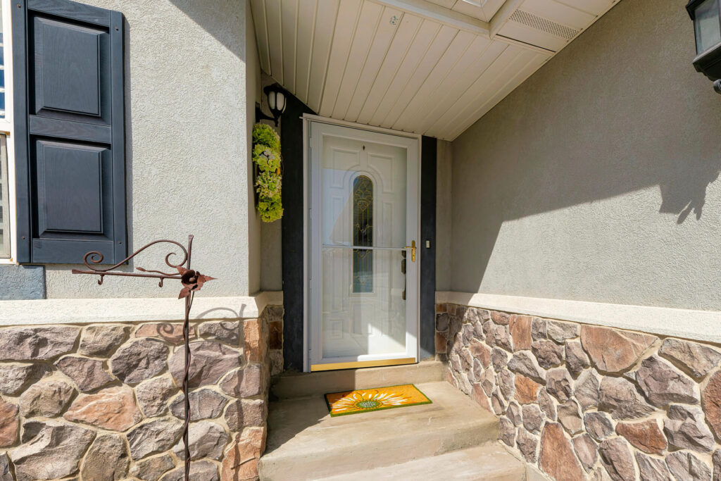 White coloured matched storm door.